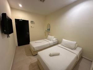 Postel nebo postele na pokoji v ubytování 1108 Hotel Sungkai