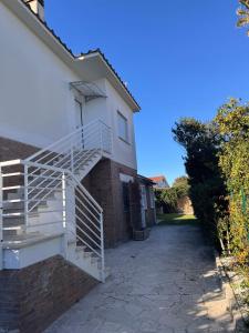 a white staircase on the side of a house at La Casa Vista Mare in Fregene +10 photos