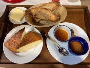 a tray with two plates of bread and two bowls of soup at Cal Carlà de Belltall in Belltal