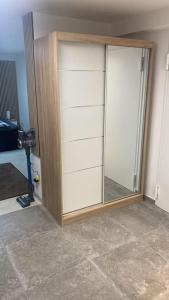 a closet with a glass door in a room at Appartment Kuschelecke in Kiefersfelden