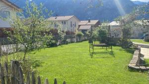 a yard with a swing in the grass at Appartment Kuschelecke in Kiefersfelden