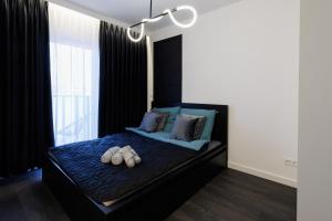 a bedroom with a bed with blue sheets and pillows at In&cognito Apartments Głogów with Parking and WiFi in Głogów