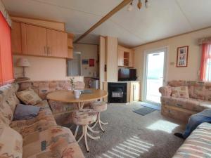 a living room with a couch and a table at D21 Kirbys Retreat 1, skegness in Winthorpe