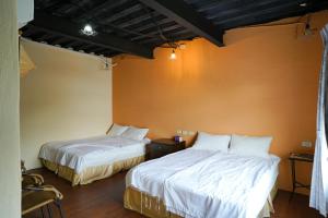 Una cama o camas en una habitación de Liu Fu Shan Zhuang