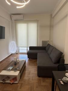 a living room with a couch and a table at Hidden Gem Apartment in Patra