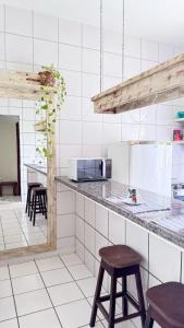 Una cocina con encimera y taburetes. en TRANCOSO, Ap Center Braga, en Trancoso