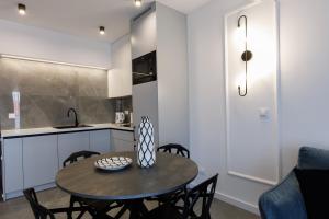 a kitchen and dining room with a table and chairs at In&cognito Apartments Głogów with Parking and WiFi in Głogów