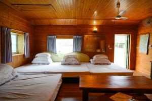 Una cama o camas en una habitación de Liu Fu Shan Zhuang