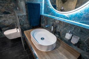 a bathroom with a sink and a mirror at Castle Apartments in Zvolen +16 photos