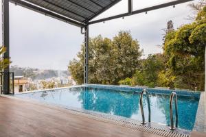 a swimming pool on the roof of a house at Mhendo Hotel & Studio Suites in Kathmandu