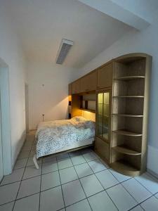 a bedroom with a bed and a book shelf at Atelier Suite in Reutlingen