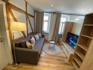 a living room with a couch and a flat screen tv at Sanierter Altbau am Schloß in Marktbreit
