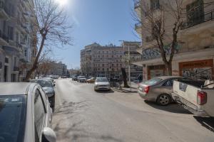 une rue de la ville avec des voitures garées sur le côté de la route dans l'établissement Urban Pulse by #db premium stay apartments, à Thessalonique