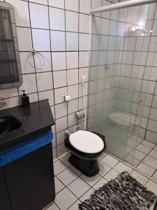 a bathroom with a toilet and a sink and a shower at Pousada Elizondo in Natal
