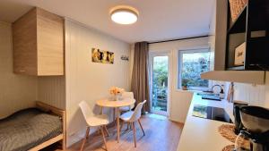 a small kitchen and dining room with a table and chairs at Leilighet midt i Sokndal sentrum in Sokndal +22 photos
