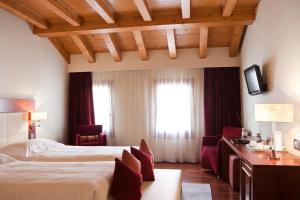 Posteľ alebo postele v izbe v ubytovaní Al Tezzon Hotel