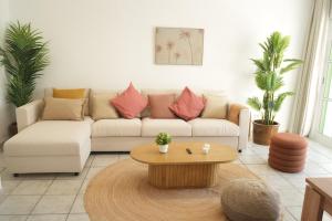 a living room with a couch and a coffee table at Pura Vida by Maspalomas Holiday Villas in Pasito Blanco