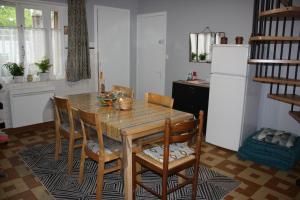 a kitchen with a table and chairs and a refrigerator at La Gâtinaise in Châtillon-Coligny +11 photos