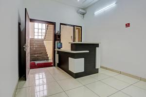 an empty room with a counter and a staircase at Super Hotel O Park Inn Near Parashuram Chowk in Morādābād