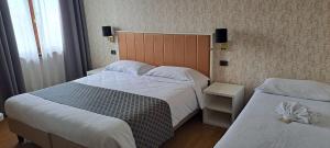 Postel nebo postele na pokoji v ubytování Hotel B&B Fortuna
