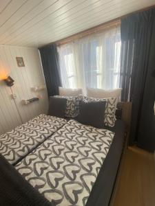 a bedroom with a bed with a comforter on it at Cosy apartment in heritage protected swiss chalet in Interlaken