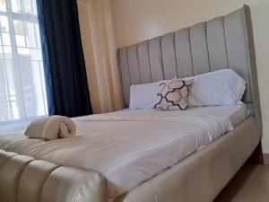 a large white bed with a stuffed animal on it at Nash issah - 2BEDROOM Excutive Air in Nakuru