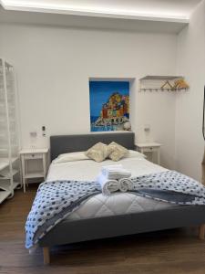 a bedroom with a bed with a painting on the wall at Bea Affittacamere in La Spezia +28 photos