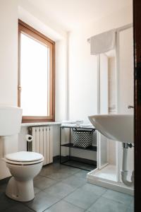 a bathroom with a toilet and a sink at Casale Center in Casale Monferrato +11 photos