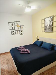 a bedroom with a bed with two towels on it at Aitana Apartment in Gran Alacant