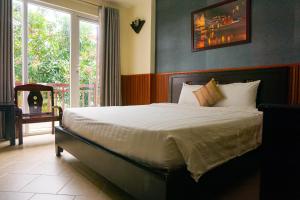 Ένα ή περισσότερα κρεβάτια σε δωμάτιο στο Paradise Hotel Hoi An