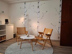 a living room with two chairs and a table at Prenočišče Breza in Radovljica