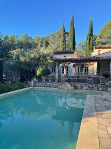 a swimming pool in front of a house at Le Mas de la Rose in Taradeau +29 photos