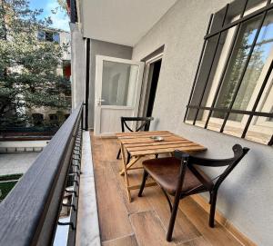 a patio with a wooden table and chairs on a balcony at Armagan Suite Taksim in Istanbul
