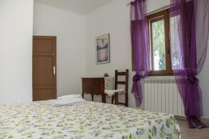 Postel nebo postele na pokoji v ubytování Podere i Giganti