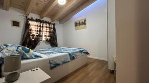 a small bedroom with a bed and a window at by Osibov, holiday home near Split with pool in Kaštela +149 photos