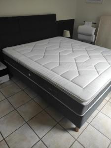 a mattress sitting on a bed frame in a room at VILLA AVEC PISCINE au calme ! in Rochefort-du-Gard