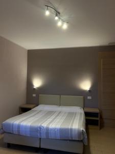 a bedroom with a bed with lights on the wall at Casa Giardinetto in Stresa
