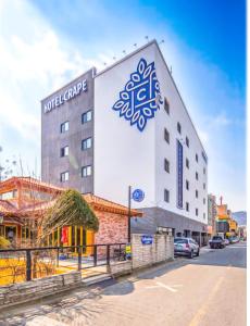 a building with a sign on the side of it at Hotel Crape Gyeongsan in Gyeongsan