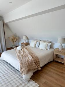 a bedroom with a bed with a blanket and pillows at L ecrin de Rosheim, villa d exception, piscine in Rosheim