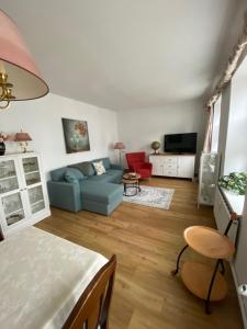 a living room with a blue couch and a tv at Jan`s FeWo in Bad Doberan