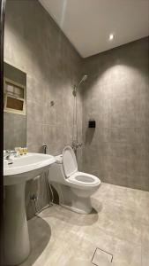 a bathroom with a toilet and a sink at شقق ثري ستار للشقق المخدومة 4 in Riyadh +26 photos