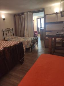 a hotel room with two beds and a table at Residence nel verde e nei trulli in Martina Franca
