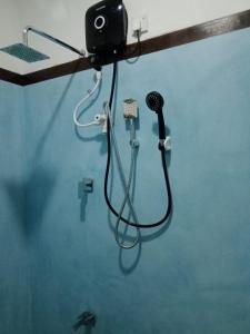 a bathroom with a blow dryer and a microphone at Homestay Midigama East, Free Washer, Wi-Fi in Midigama
