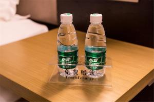 two bottles of water sitting on top of a table at Lavande Hotel Foshan Shunde Ronggui in Shunde