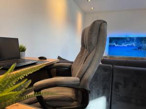 a chair in front of a desk with a laptop at Apartment Bacci in Vrhnika