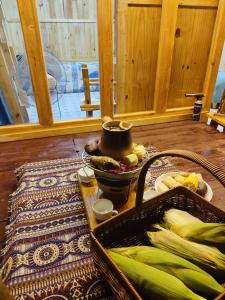 a table with a pot and a basket of vegetables at Natural Garden BMT in Buon Ma Thuot +35 photos