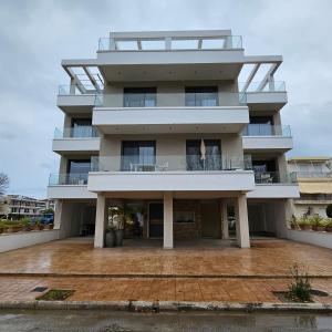 a large white building with a balcony at Philia Luxury Living in Nei Poroi +1 photo