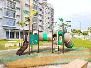 a playground in a park in front of a building at GRANDE MAISON 3 NEAR AFAMOSA WaterPark in Kampong Pulau Sebang