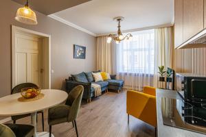 a living room with a table and a couch at Amber Apartment in Riga