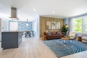 a kitchen and living room with a couch and a table at Spacious Getaway 15mins from Downtown Atlanta in Decatur